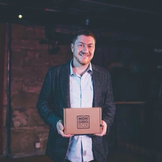Terence holding the My Non-GMO Box on stage at Bellingham Pitch Fest